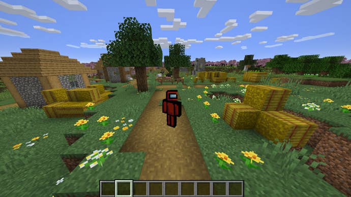 The player wears the red Among Us Imposter Minecraft skin while standing near a village