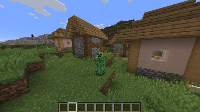 The player, wearing the Creeper skin, stands in a plains village in Minecraft