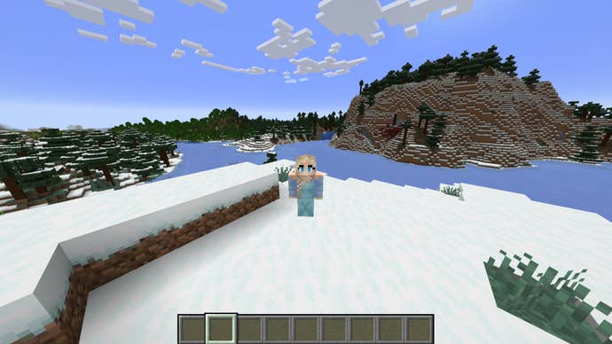 The player, wearing the Elsa skin, stands on some snow beside a frozen river in Minecraft