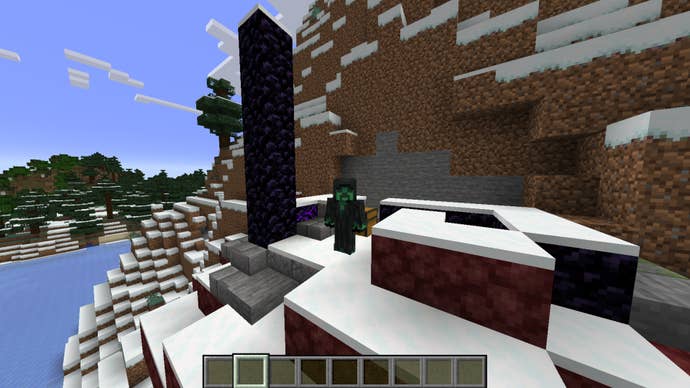 The player, wearing the Grim Creeper skin, stands next to a ruined nether portal in a snowy biome in Minecraft