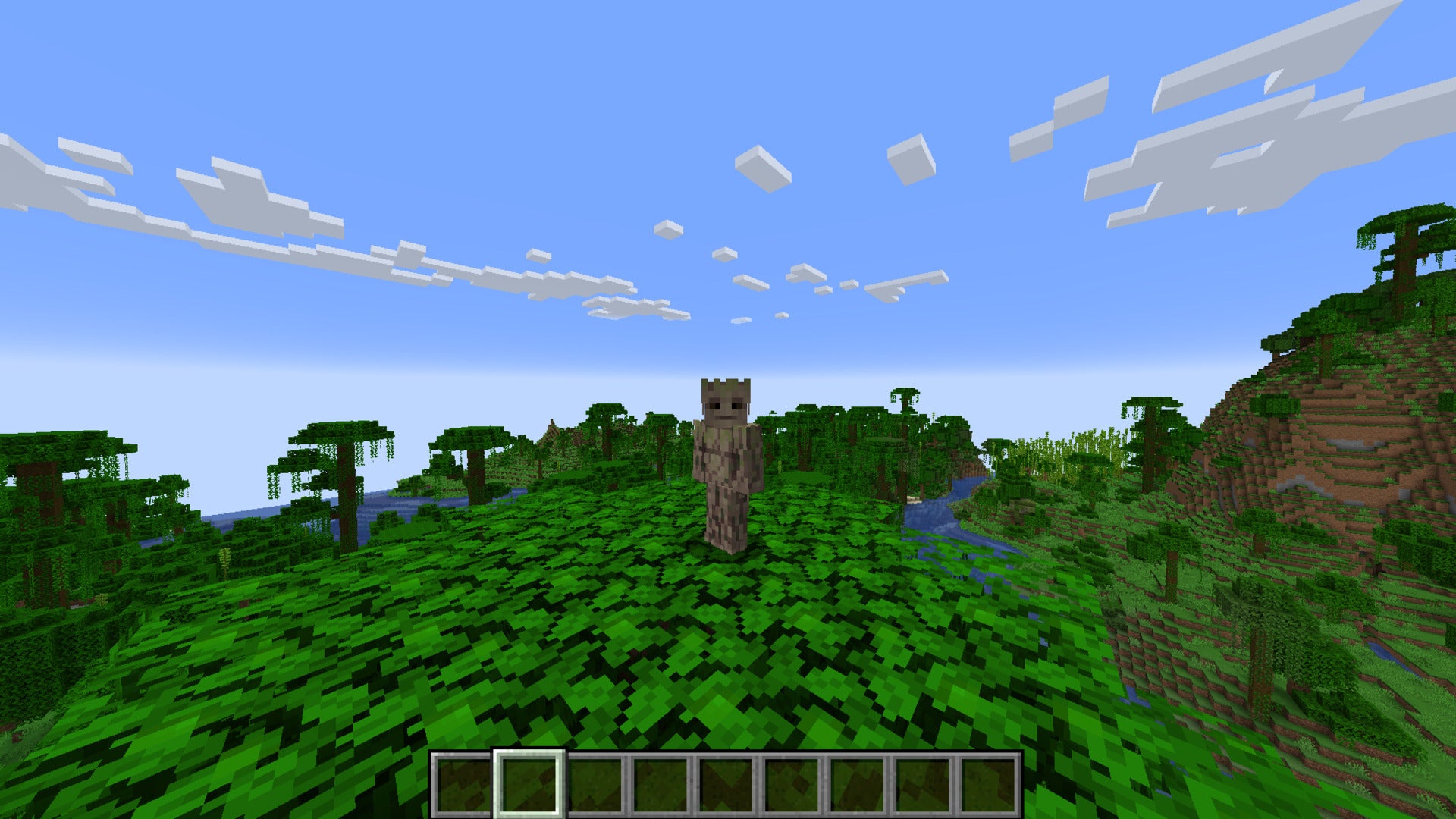 The player, wearing the Groot skin, stands atop a tree in the jungle biome in Minecraft - 31