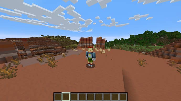 The player, wearing the Maxwell (Scribblenauts) skin, stands in the badlands biome in Minecraft