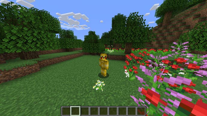 The player, wearing the Pikachu skin, stands in a meadow in Minecraft