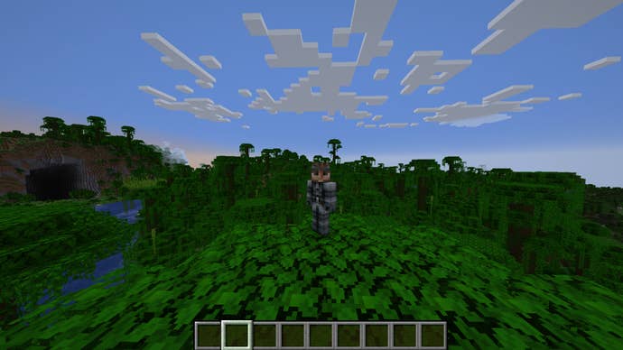 The player, wearing the Solid Snake skin, stands atop a tree in a jungle in Minecraft