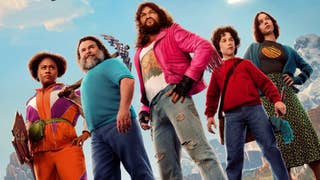 The cast of A Minecraft Movie (five people) pose next to each other in something like battle stances. Lots of them are holding weapons.
