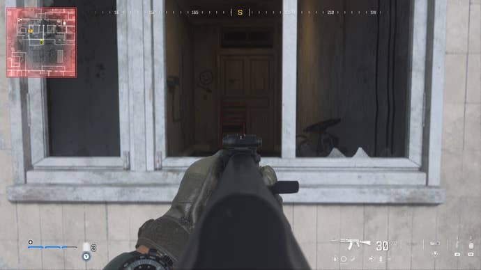 looking through a window at a chair blocking a door