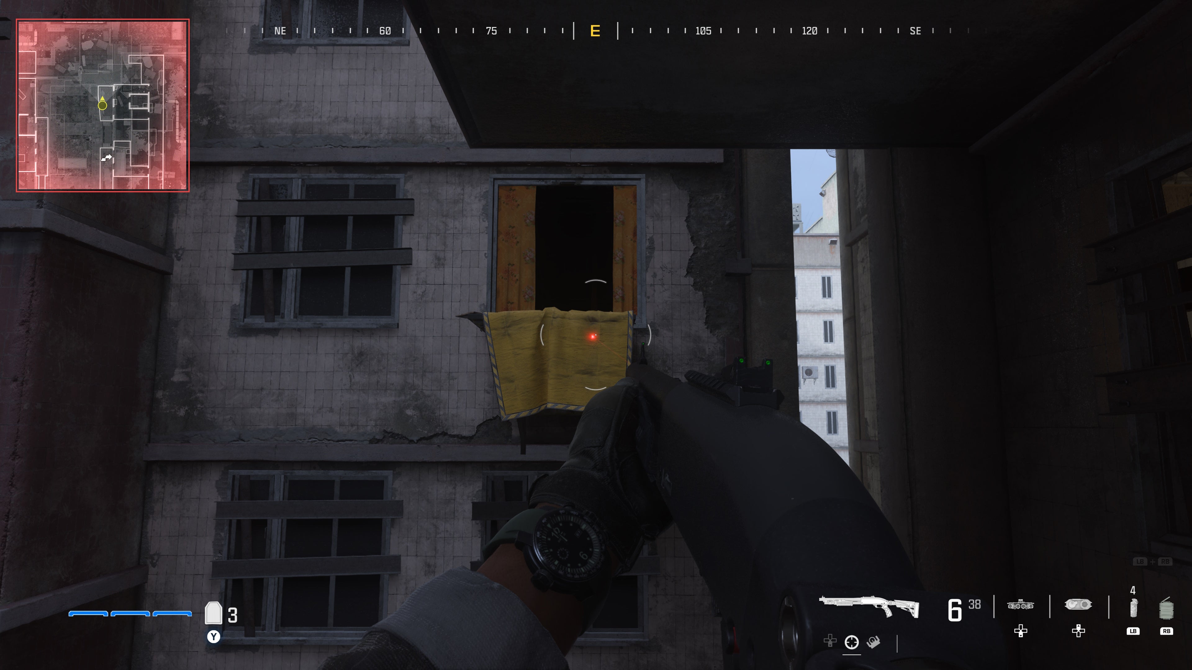 looking at an open window on a dilapidated building with yellow tarp hanging below the window