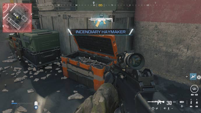 looking at an item in an open orange supply box on the reactor level