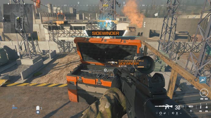 looking at an item in an open orange supply box on the reactor level