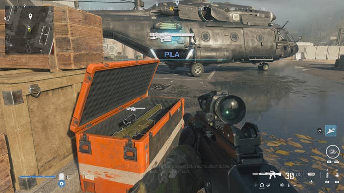 looking at an item in an open orange supply box on the reactor level