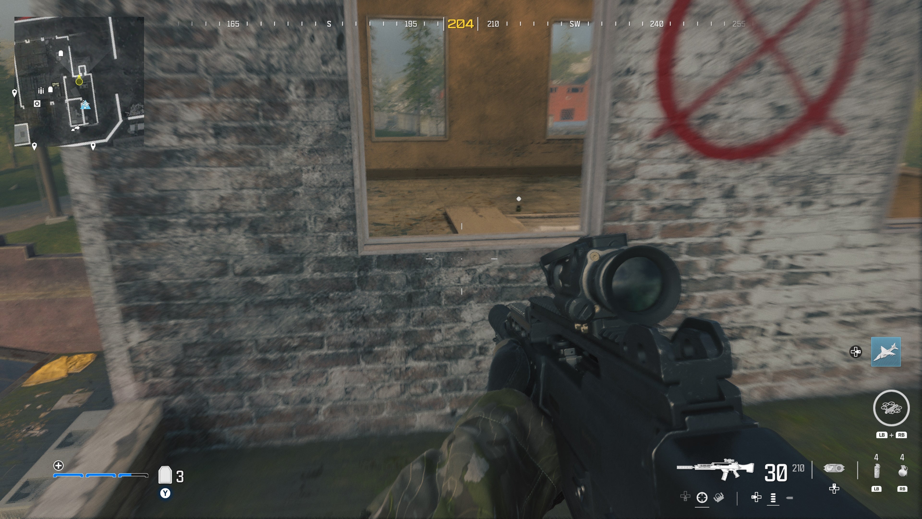 looking through a window with no pane on a washed out wall with a red circle with an &lsquo;X&rsquo; through it on the wall