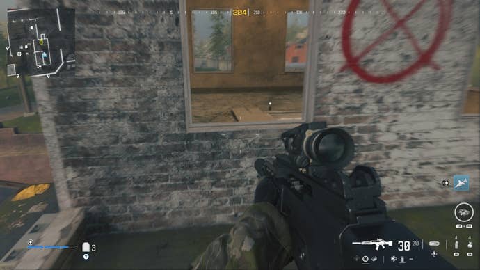 looking through a window with no pane on a washed out wall with a red circle with an ‘X’ through it on the wall