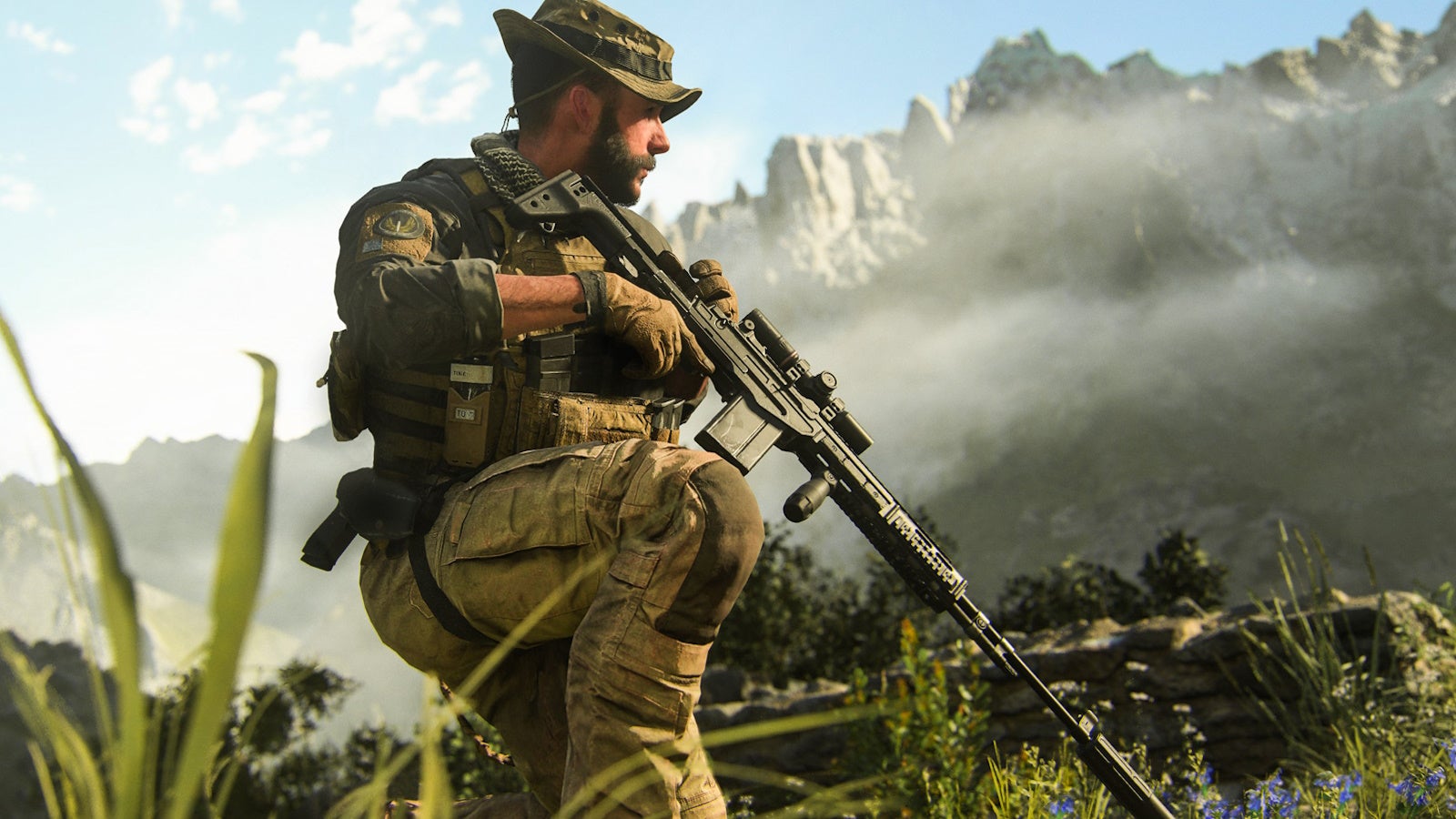 captain prive kneeling in grass holding a sniper rifle, with a huge mountain surrounded by misty clouds in the background