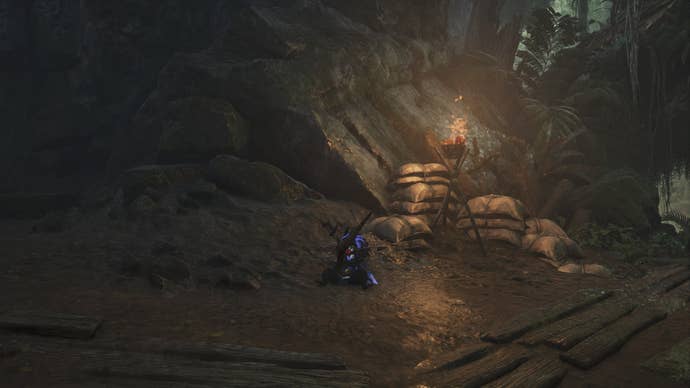 The player’s Palico can be seen near the entrance to the Scarlet Forest Base Camp in Monster Hunter Wilds