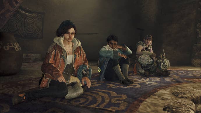 Alma, Nata, and the Hunter can be seen sat inside a tent during a cutscene in Monster Hunter Wilds