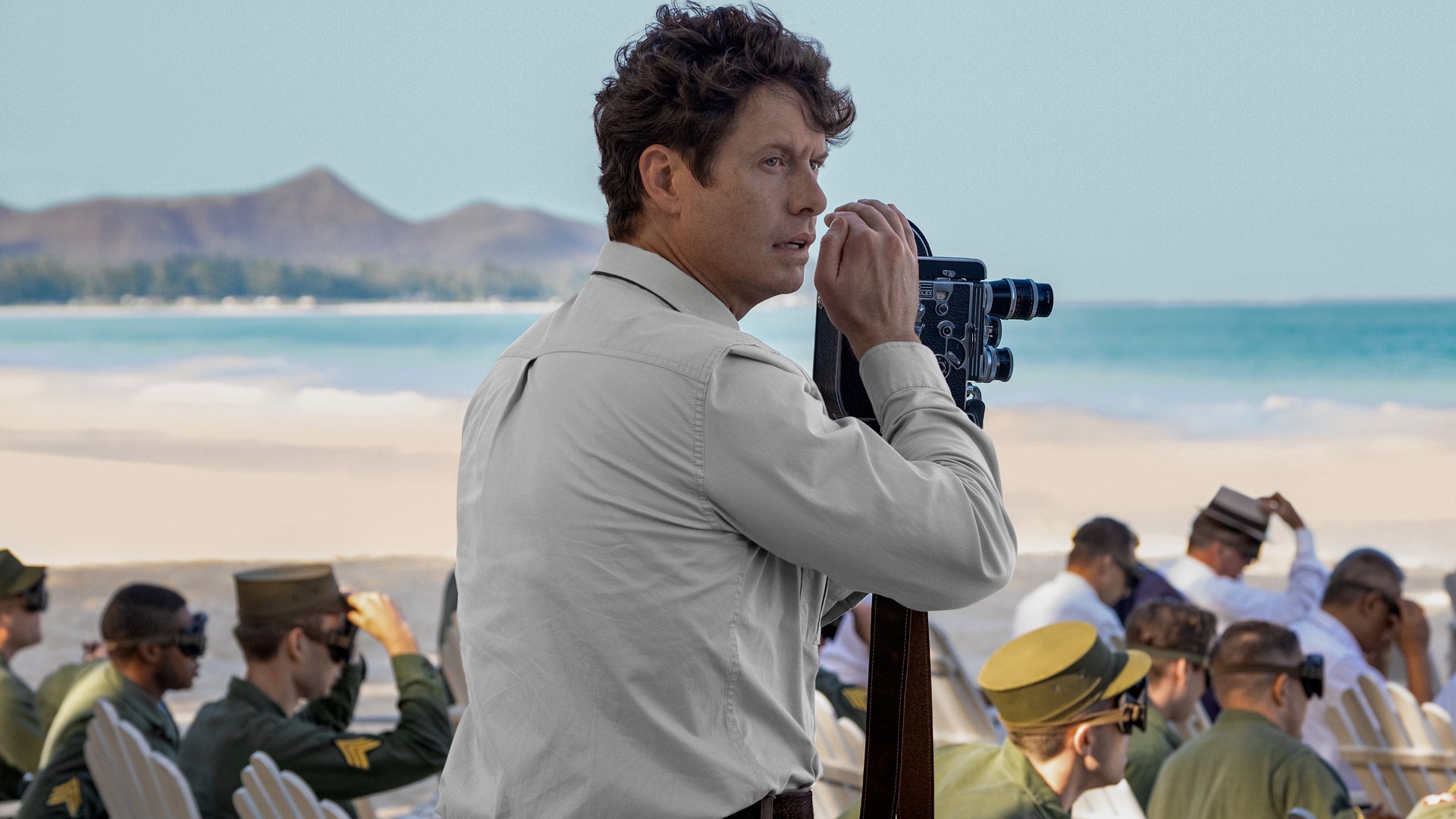 Bill Randa in Monarch Legacy of Monsters on a beach in the pacific shooting on a 16mm film camera - 4