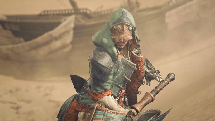 Monster Hunter Wilds screenshot showing main character in a hood holding a sword in a sand dune area