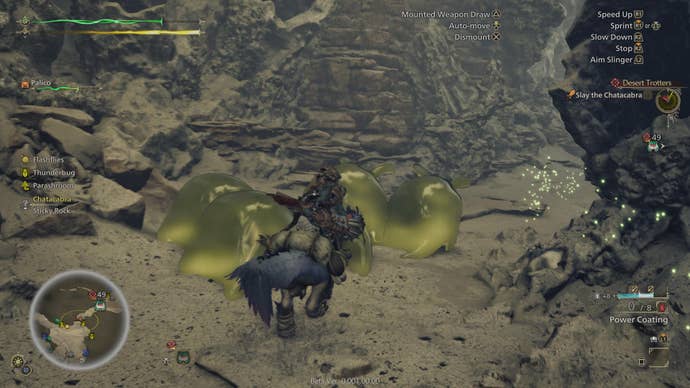 Monster Hunter Wilds beta screenshot showing player character riding past golden blobs in rocky region