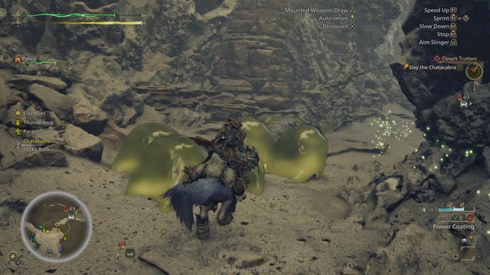 Monster Hunter Wilds beta screenshot showing the player character passing through golden spots in a rocky region