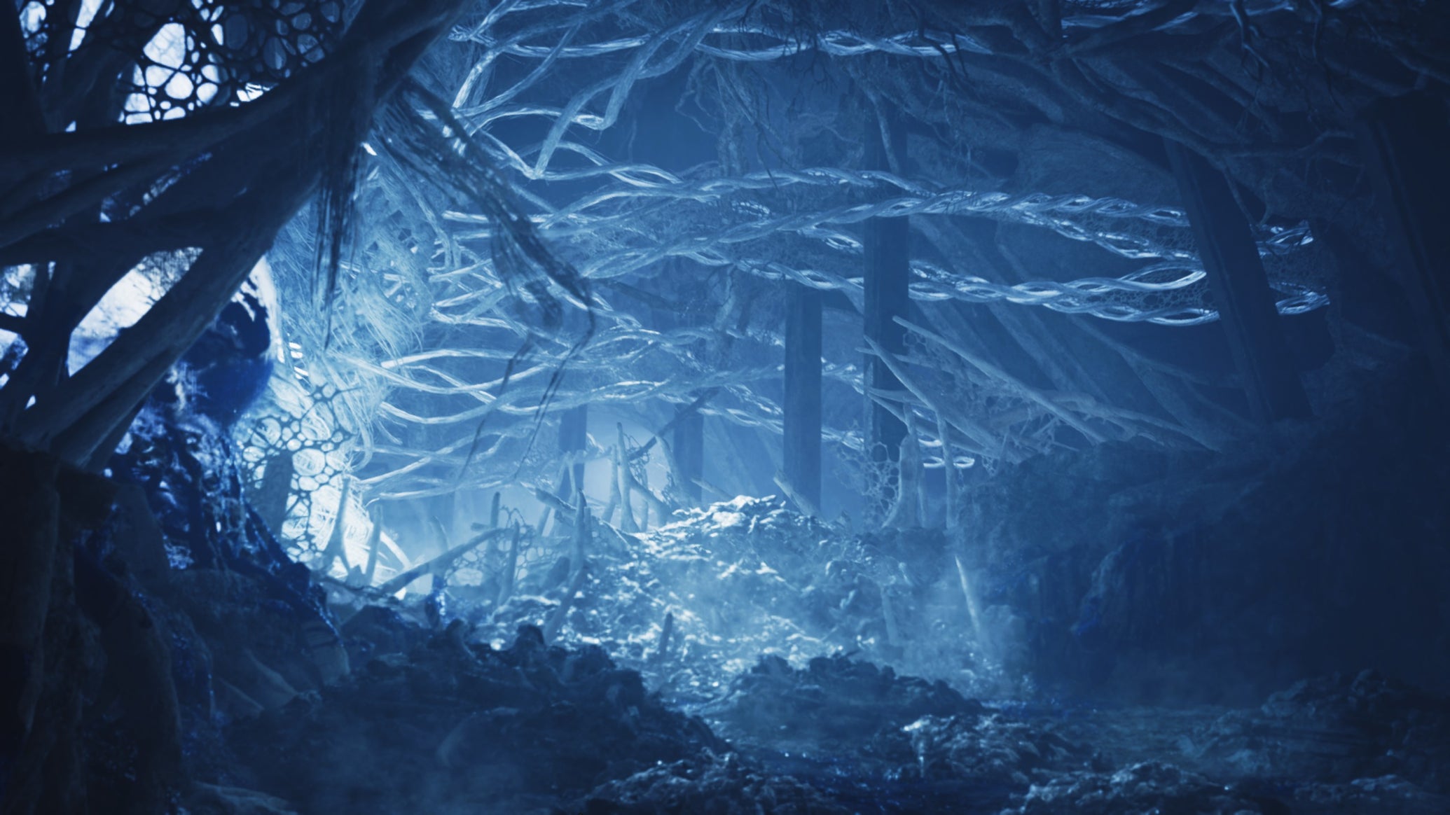 A Monster Hunter Wilds screenshot showing the icy blue cavern where the Guardian Arkveld feasts on creatures. - 1