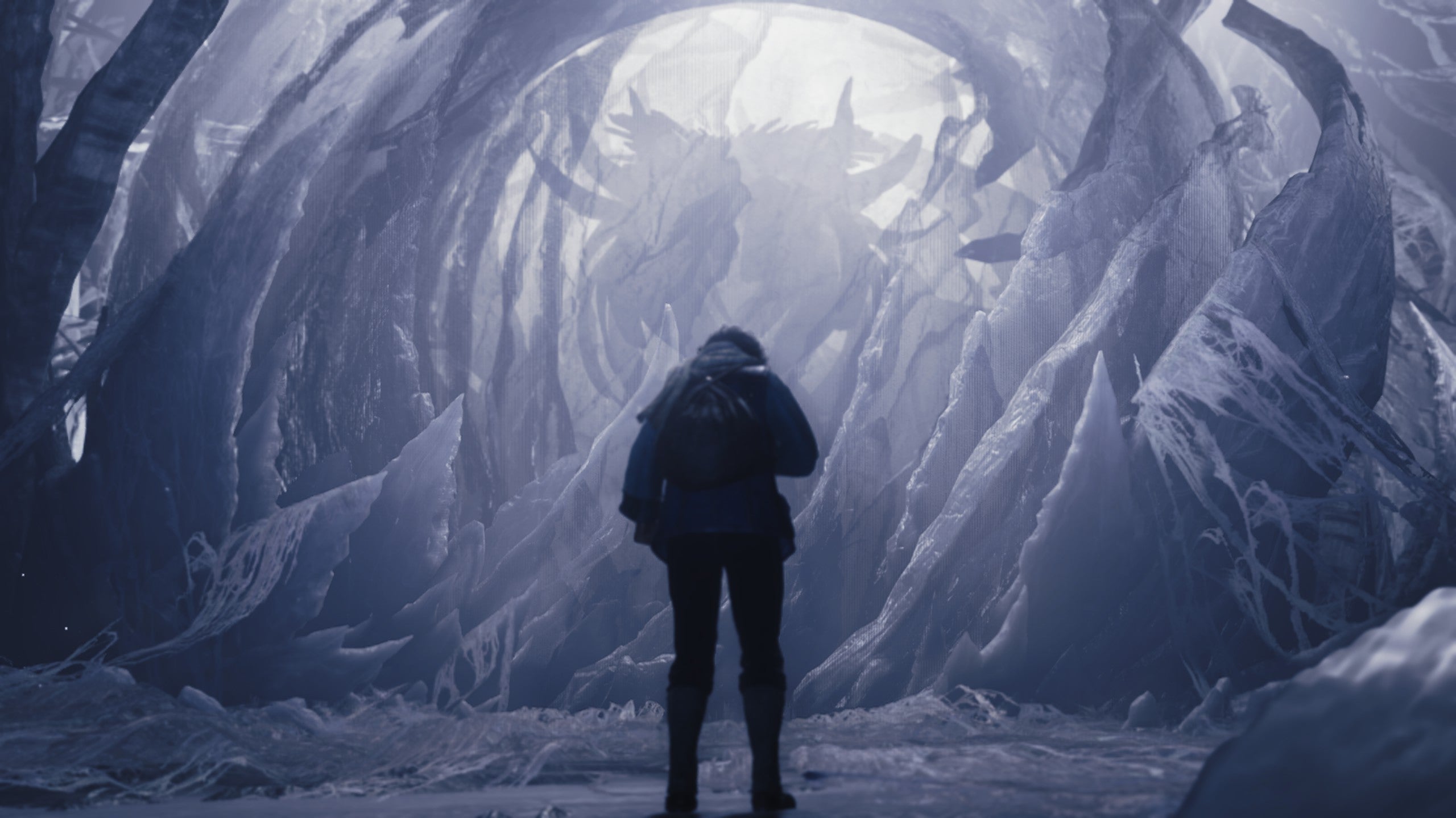 A Monster Hunter Wilds screenshot shows Nata standing in front of Zoh Shia&rsquo;s frozen chrysalis while looking down.