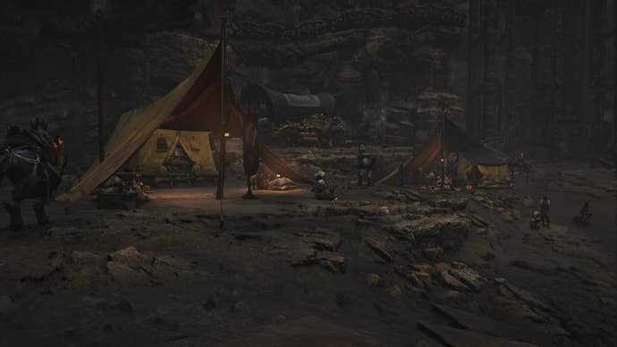 A Monster Hunter Wilds screenshot of the Oilwell Basin Base Camp showing the hunter’s yellow tent among others.