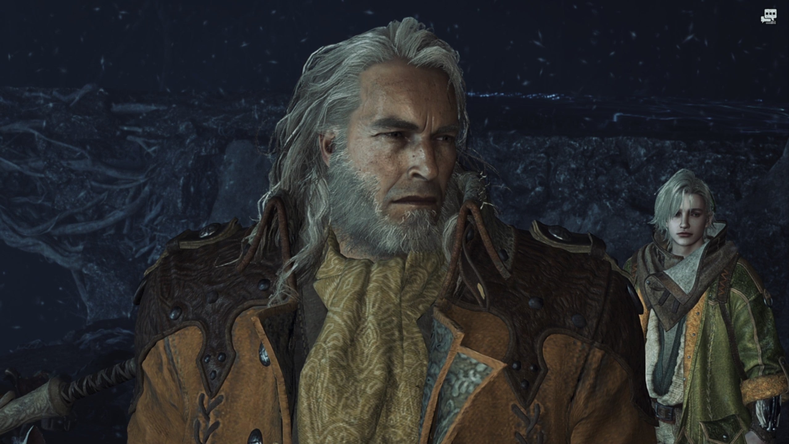 A Monster Hunter Wilds snowing screenshot close-up of Fabius with Erik in the background.