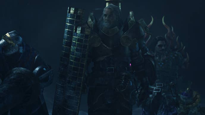 A Monster Hunter Wilds screenshot of Fabius in armour holding a large shield with the hunter in the background.