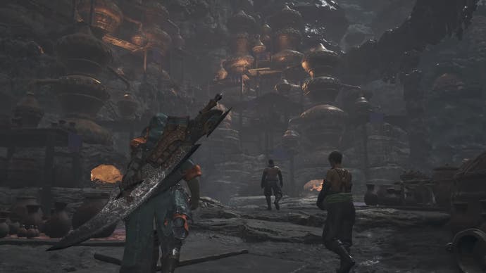 Wander through a dark cave town in Monster Hunter Wilds.