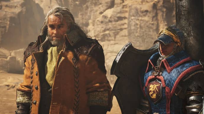 Fabius, a key NPC in Monster Hunter Wilds, stands in front of the camera with one of his lance-wielding guards at his side.