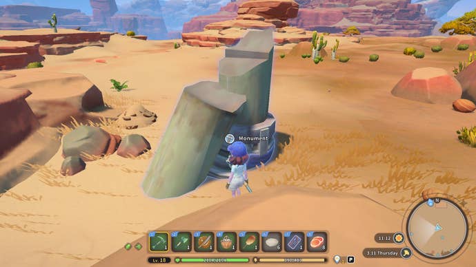 The player faces a monument in the desert behind their home in My Time at Sandrock
