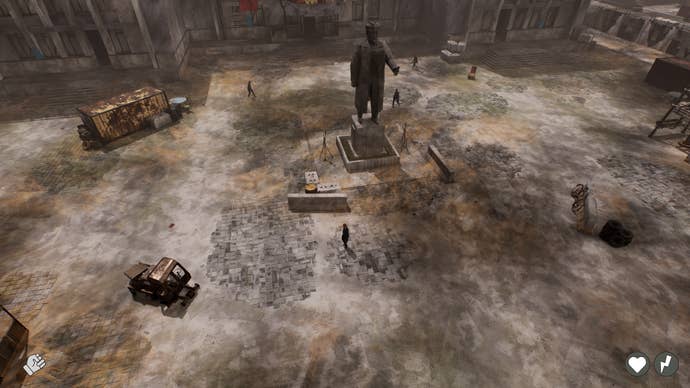 A burned-out post-apocalyptic town square with a statue in the middle and rusty vehicles, viewed from on high