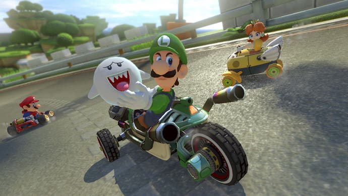 Best Mario Games - Mario Kart 8 Deluxe screenshot showing Luigi looking furious while driving a bike.