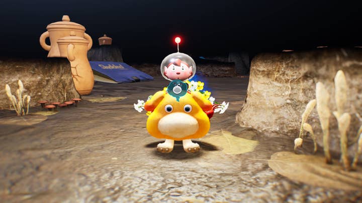 Pikmin 4 screenshot showing the player riding Oatchi the dog in a cave level. A bunch of Pikmin are also riding Oatchi, clinging to its backside