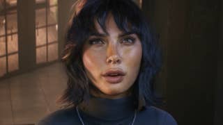 A woman with dark hair is seen talking and looking into the camera.