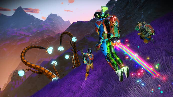 Space adventurers pose in front of tentacles that rip through the ground in No Man’s Sky’s Fractal update