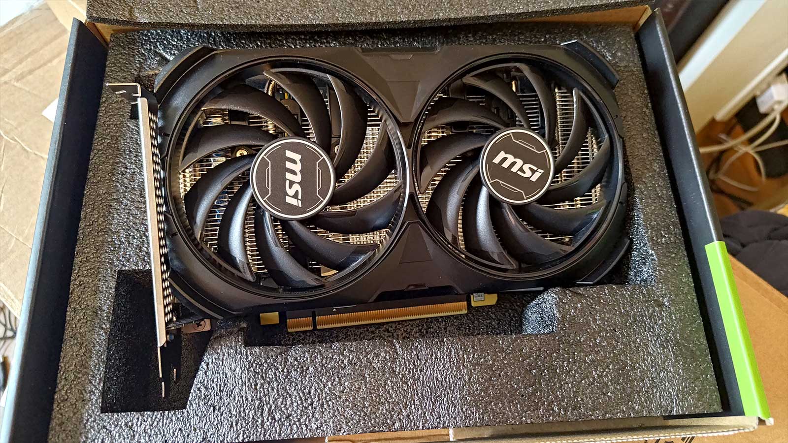 An MSI-made RTX 4060 Ti 8GB graphics card with its packagaing.
