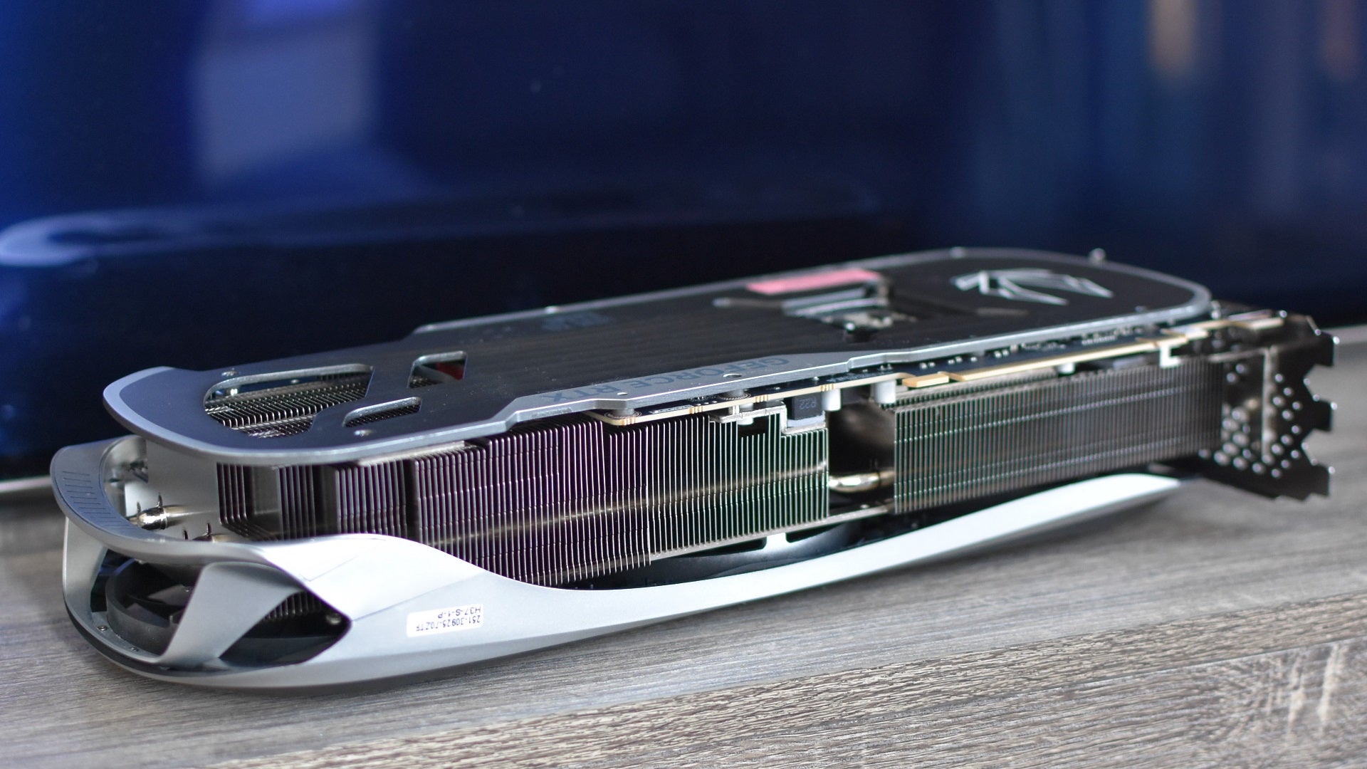 The Zotac Gaming GeForce RTX 4090 Amp Extreme Airo graphics card on a wooden table.