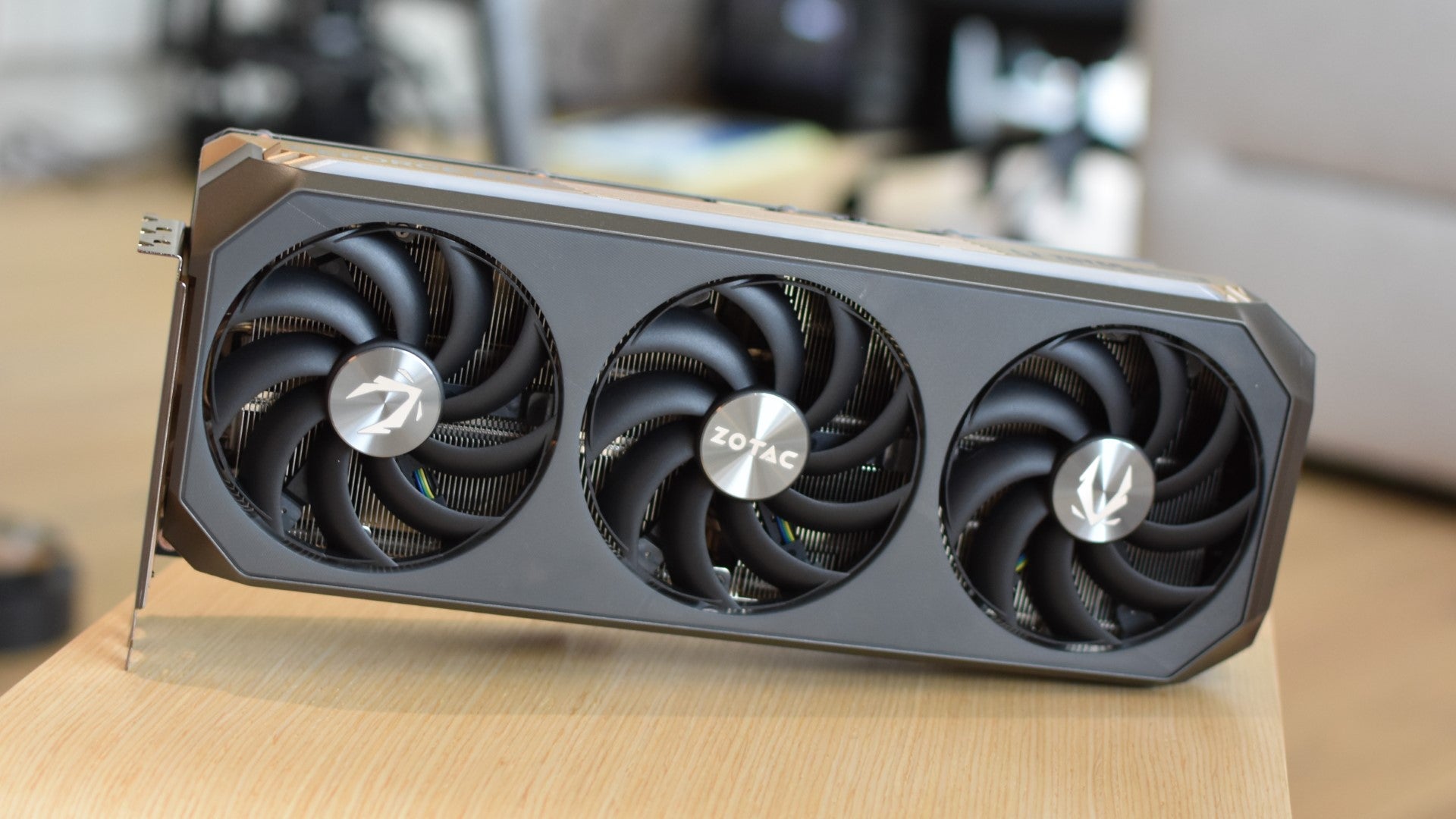 The Zotac Gaming GeForce RTX 5070 Ti AMP Extreme Infinity graphics card on a table. - 1