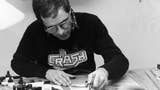 Artist Oli Frey at work, in a black and white picture, wearing a Crash magazine t-shirt.