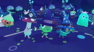 A group of Ooblets in Halloween hats dance in a neon-lit, nighttime town square.