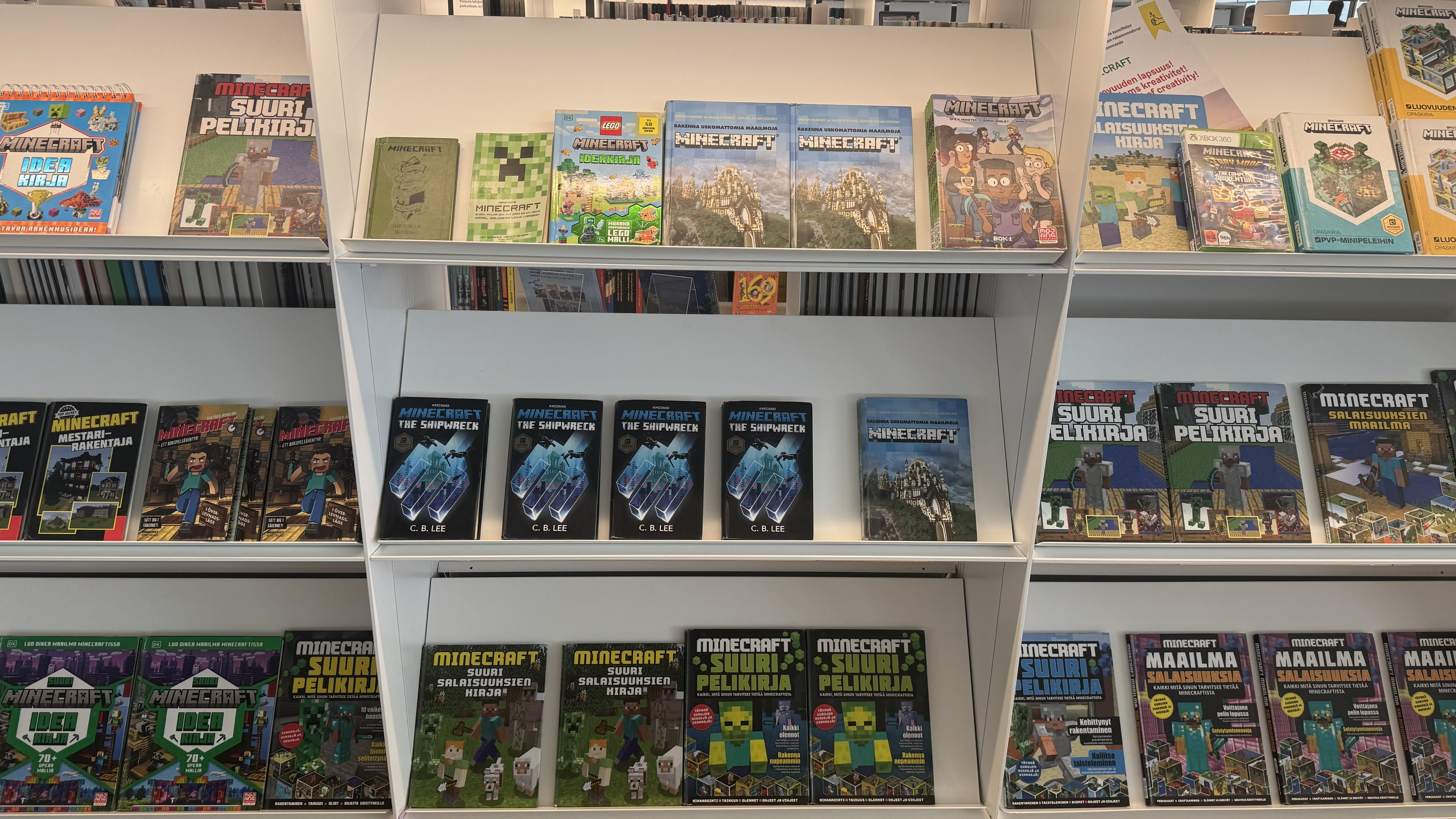 Photo of the Oodi Library in Helsinki showing children's gaming books on topics such as Minecraft on white shelves