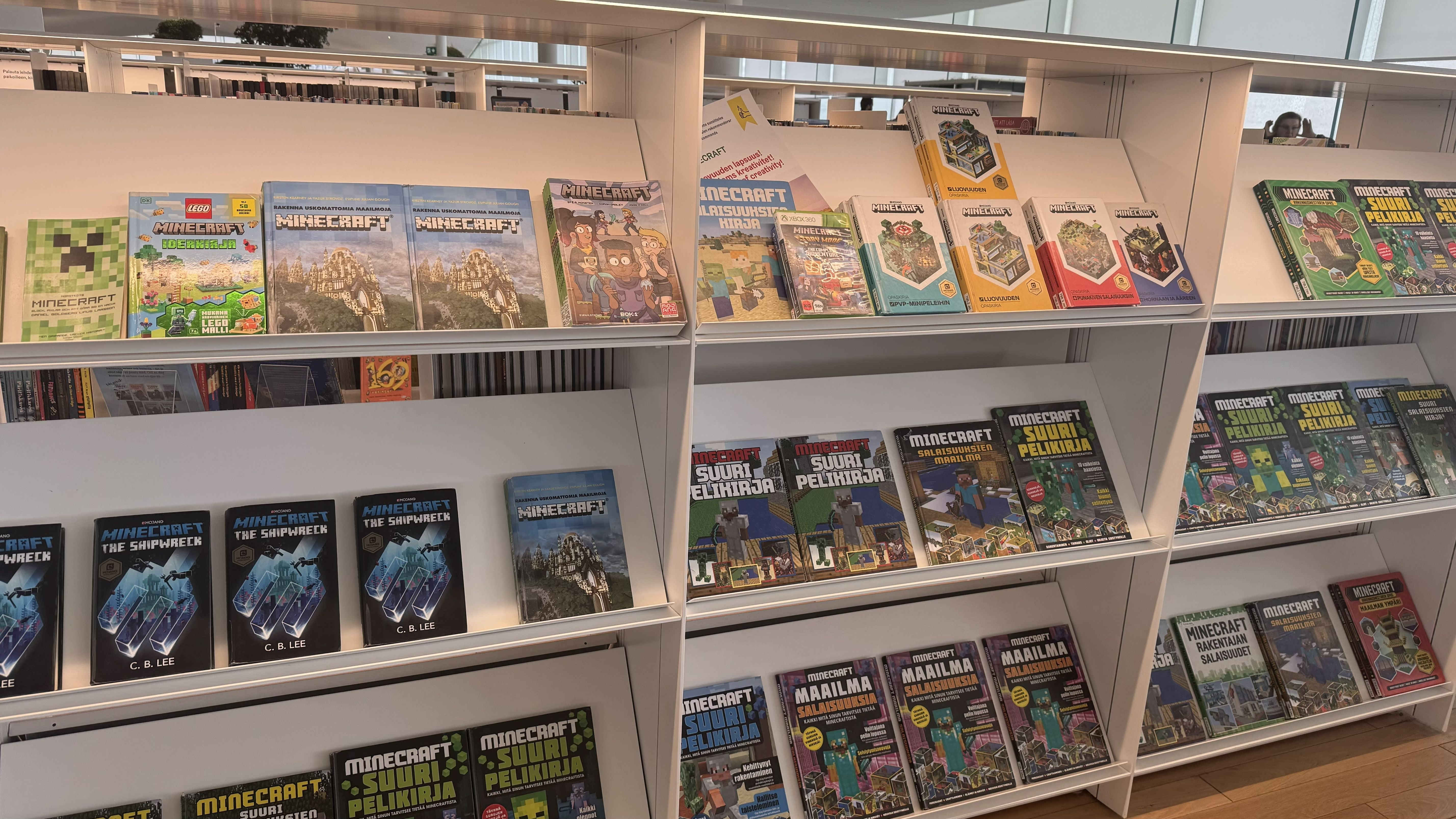 Photo of the Oodi Library in Helsinki showing children's gaming books on topics such as Minecraft on white shelves
