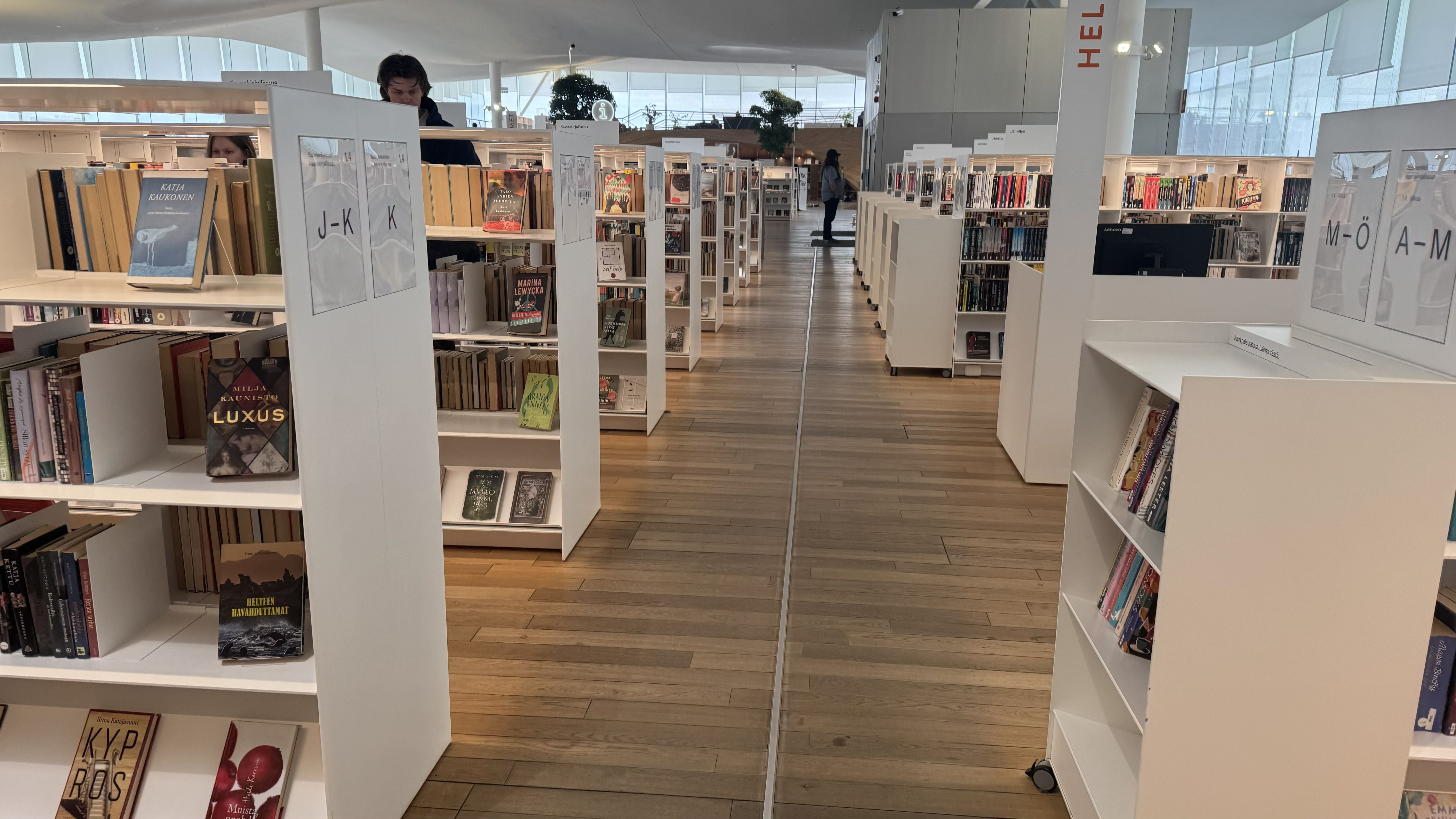 Photo of the Oodi Library in Helsinki showing rows of shelves with various books and other media