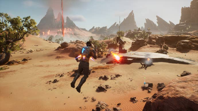 Cutter Slade in Outcast: A New Beginning holding a pistol as he jetpacks over the surface of a sandy land towards an enemy base