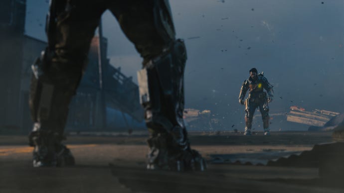 A low angle shot through a pair of menacing robot legs at a distant robot man standing on a dusty ruined road