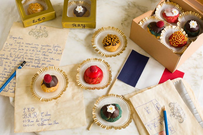 Several small baked confections laid out on fancy writing paper