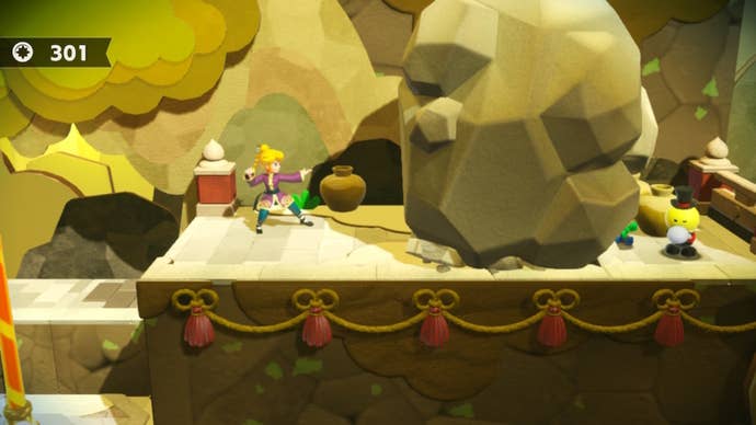 Kung Fu Peach stands beside a boulder with a Theet trapped behind it in Princess Peach: Showtime