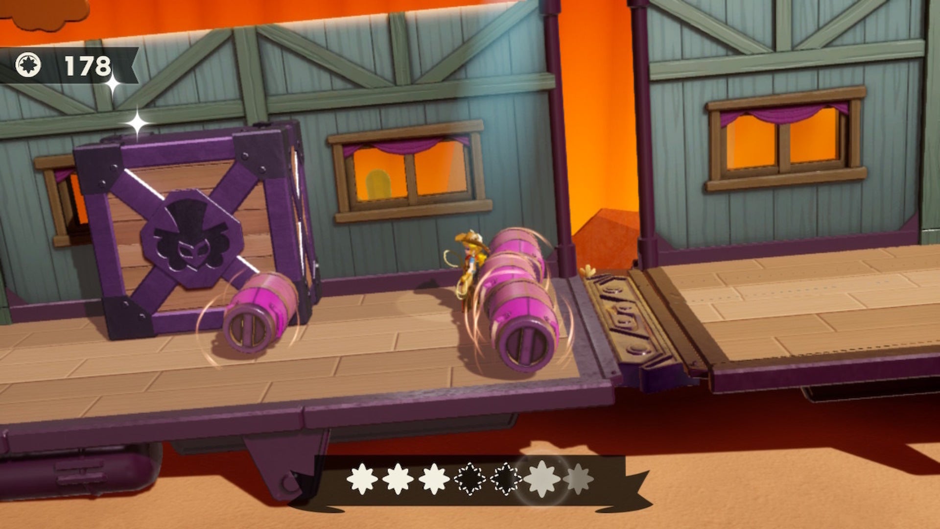 Cowgirl Peach stands between some rolling barrels on a broken runaway train in Princess Peach: Showtime - 8