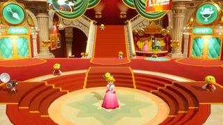 Princess Peach stands in the Sparkle Theater lobby alongside some Theets in Princess Peach: Showtime